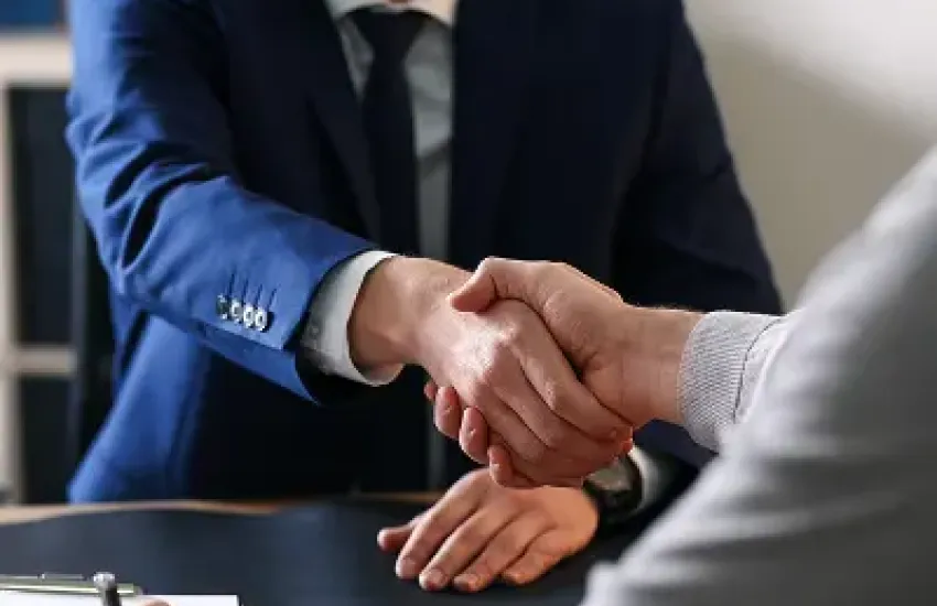 Two businessmen shaking hands to symbolize a business agreement.